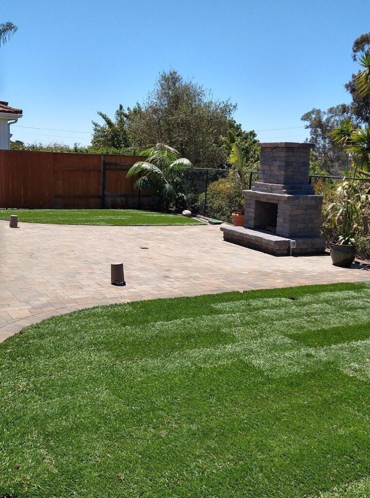 Complete backyard landscape design in San Diego with turf, pavers, and plants
