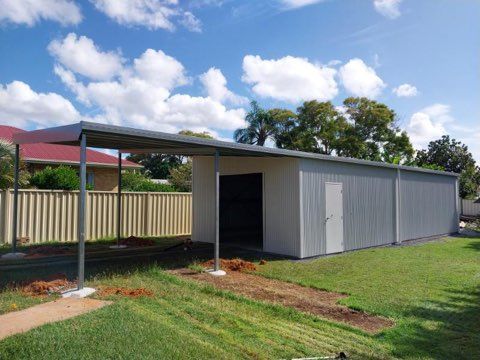White Shed in Backyard on Grass — Bundy Tiny Homes and Carports in Branyan, QLD