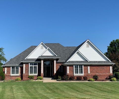 A large brick house with a gray roof and white trim