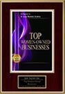 A framed picture of a book titled top women owned businesses.