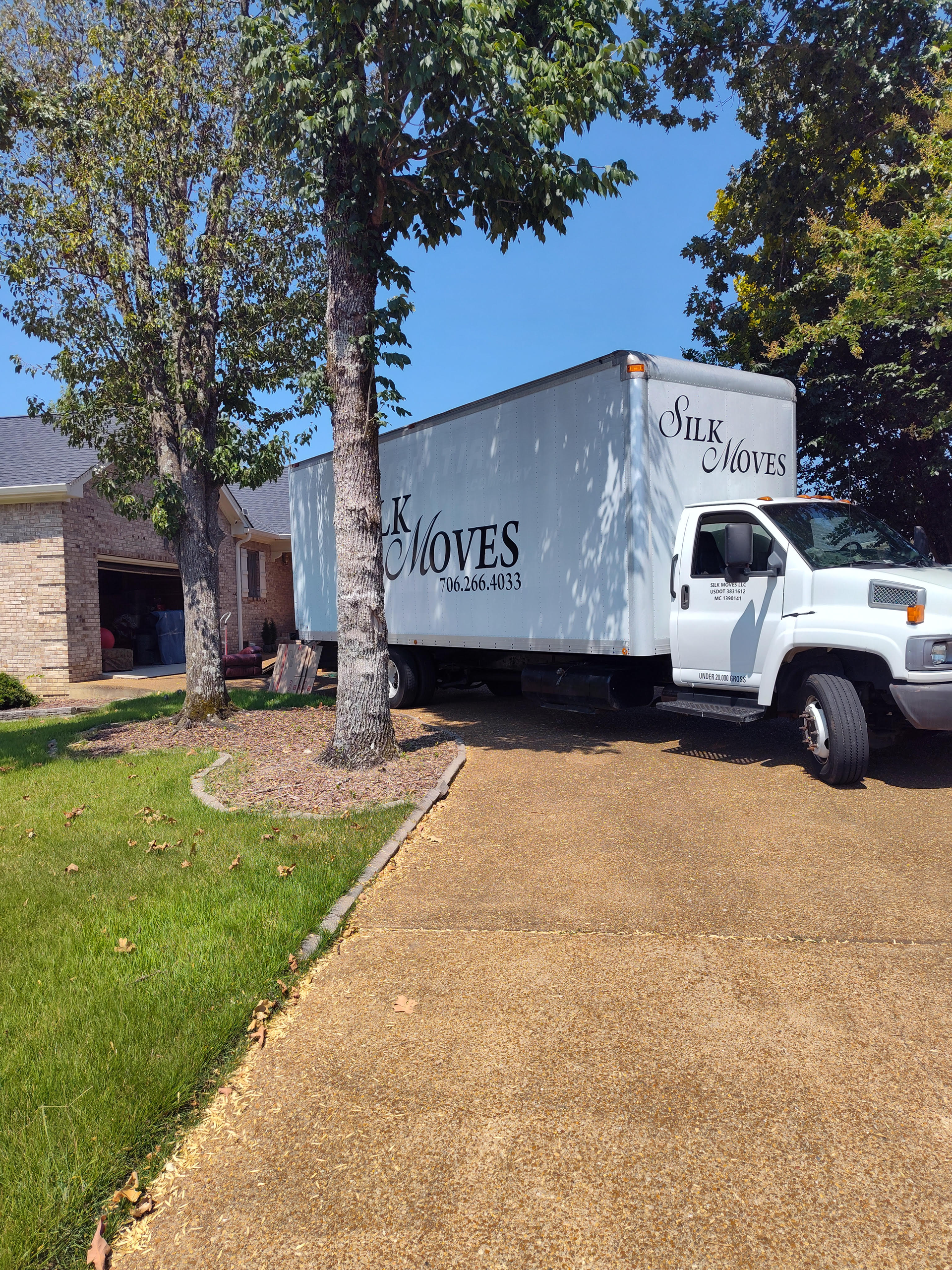 Silk Moves Truck backed up into a driveway.