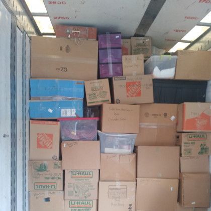 A bunch of boxes with one that says uhaul on it