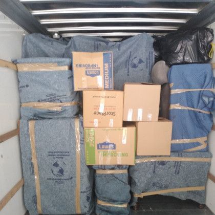 A stack of boxes with one that says medium on it