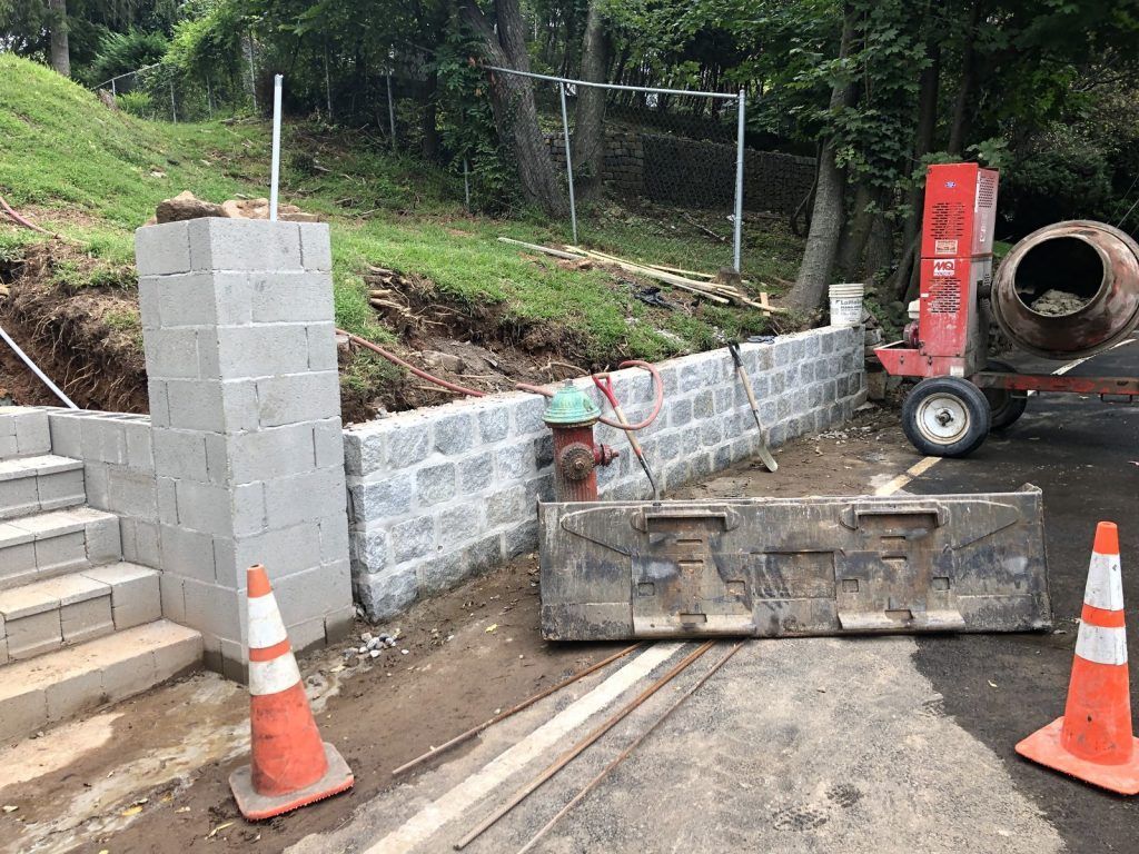 A concrete wall is being built next to a fire hydrant.