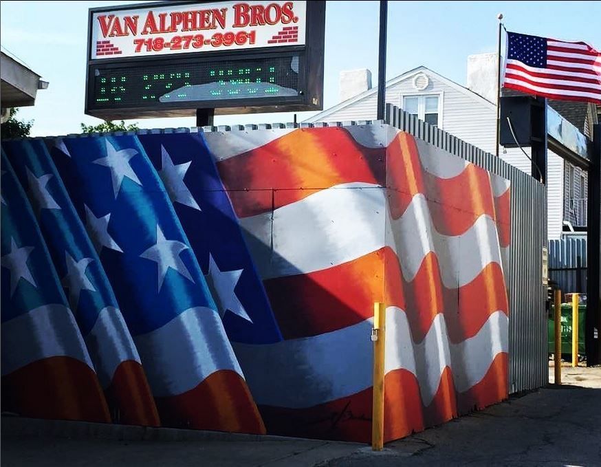A van alphen bros sign is above a fence with american flags painted on it