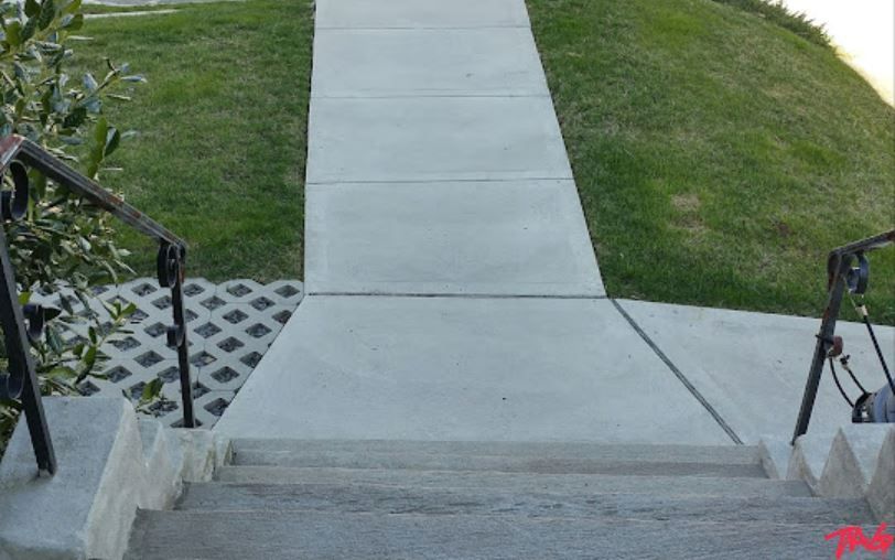 A concrete walkway with stairs leading up to it