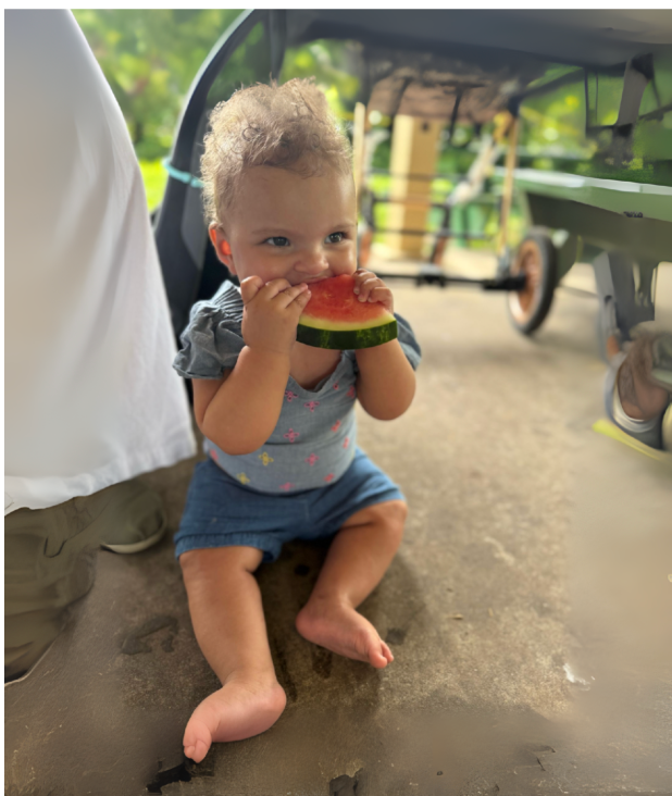 Child eating watermelon, sitting outdoors.