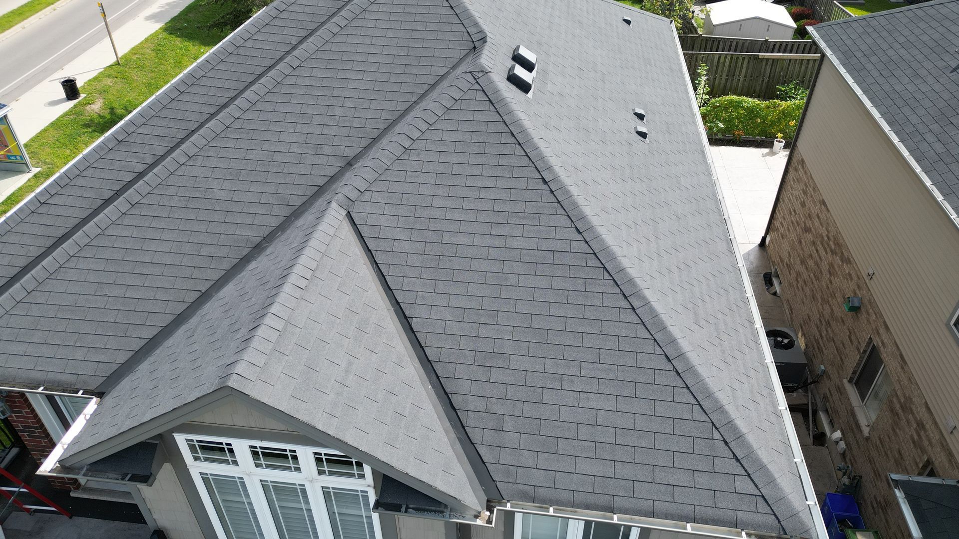 An aerial view of a house with a gray roof