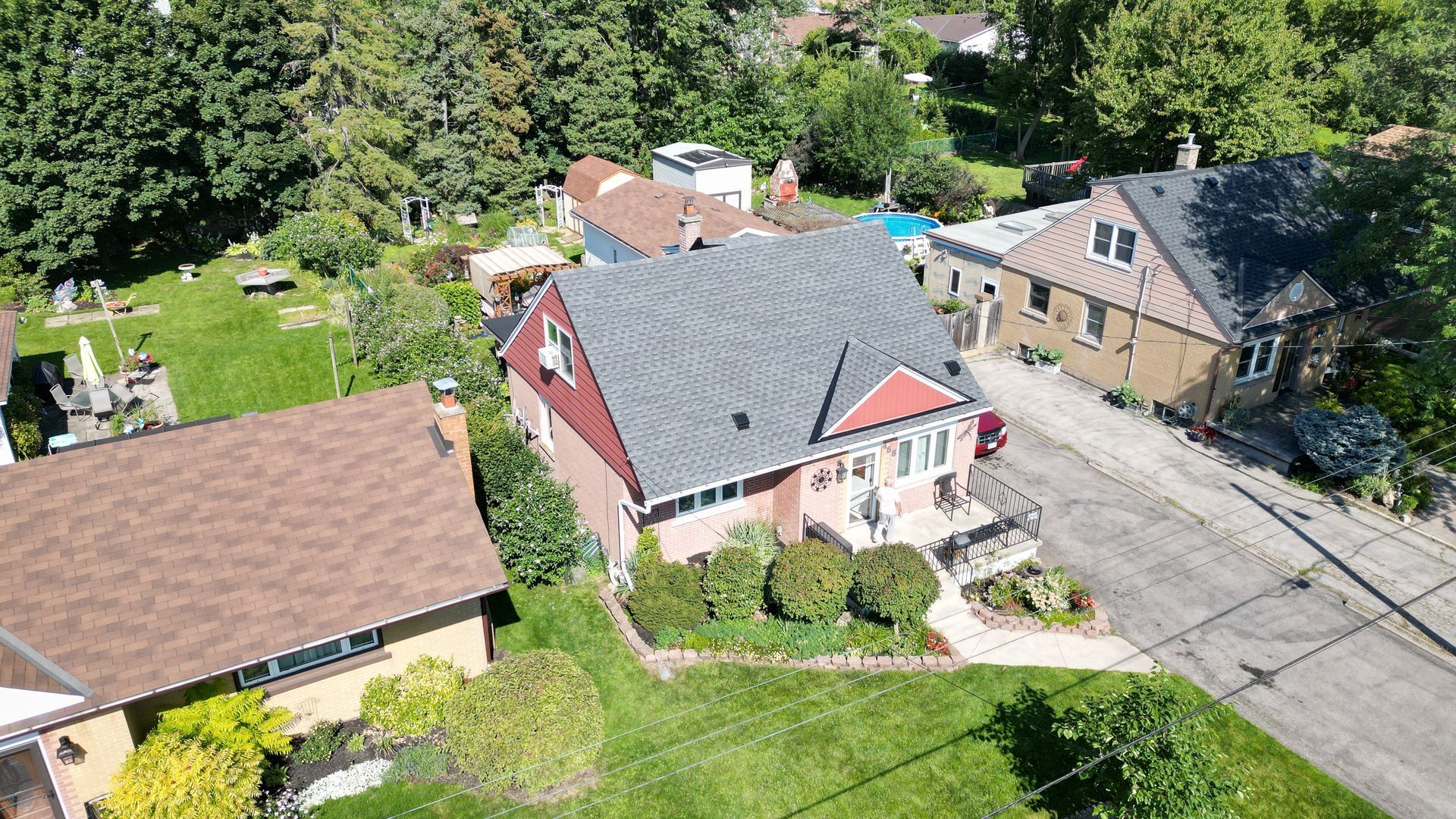An aerial view of a residential area with houses and trees