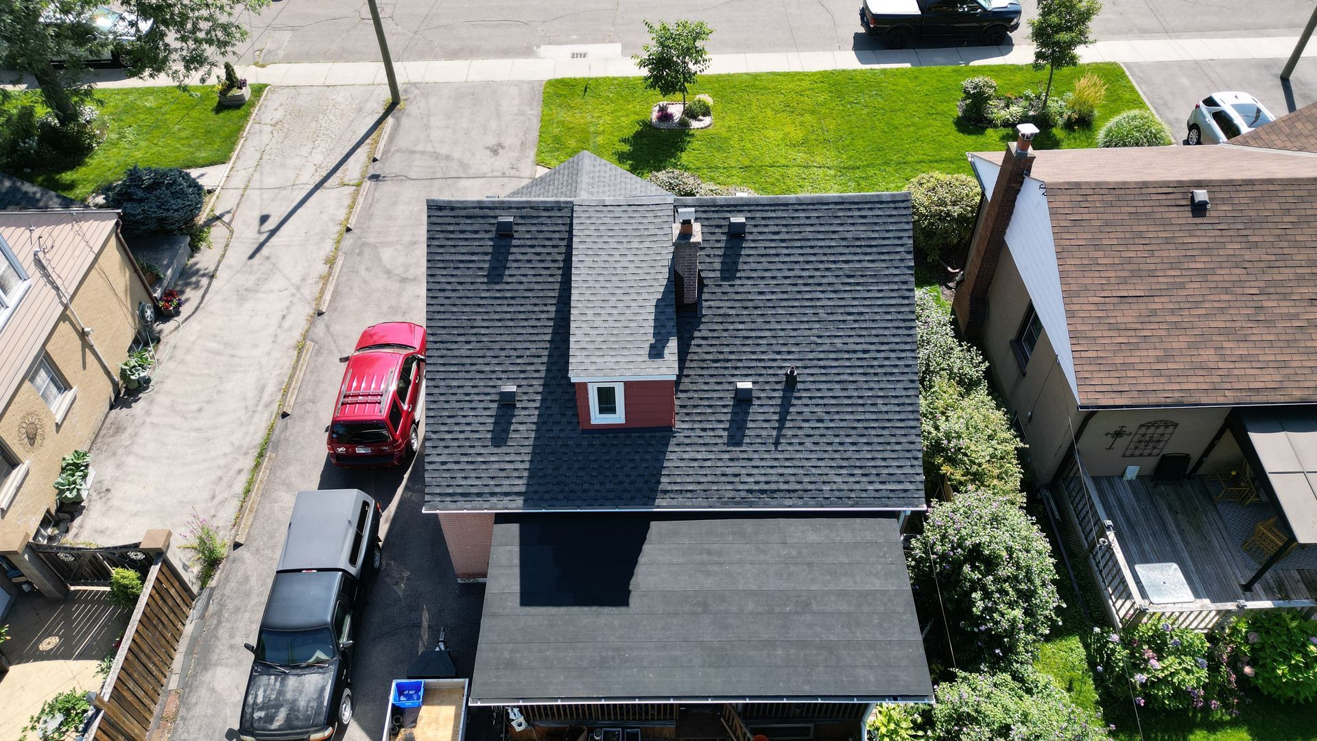 An aerial view of a house with a black roof