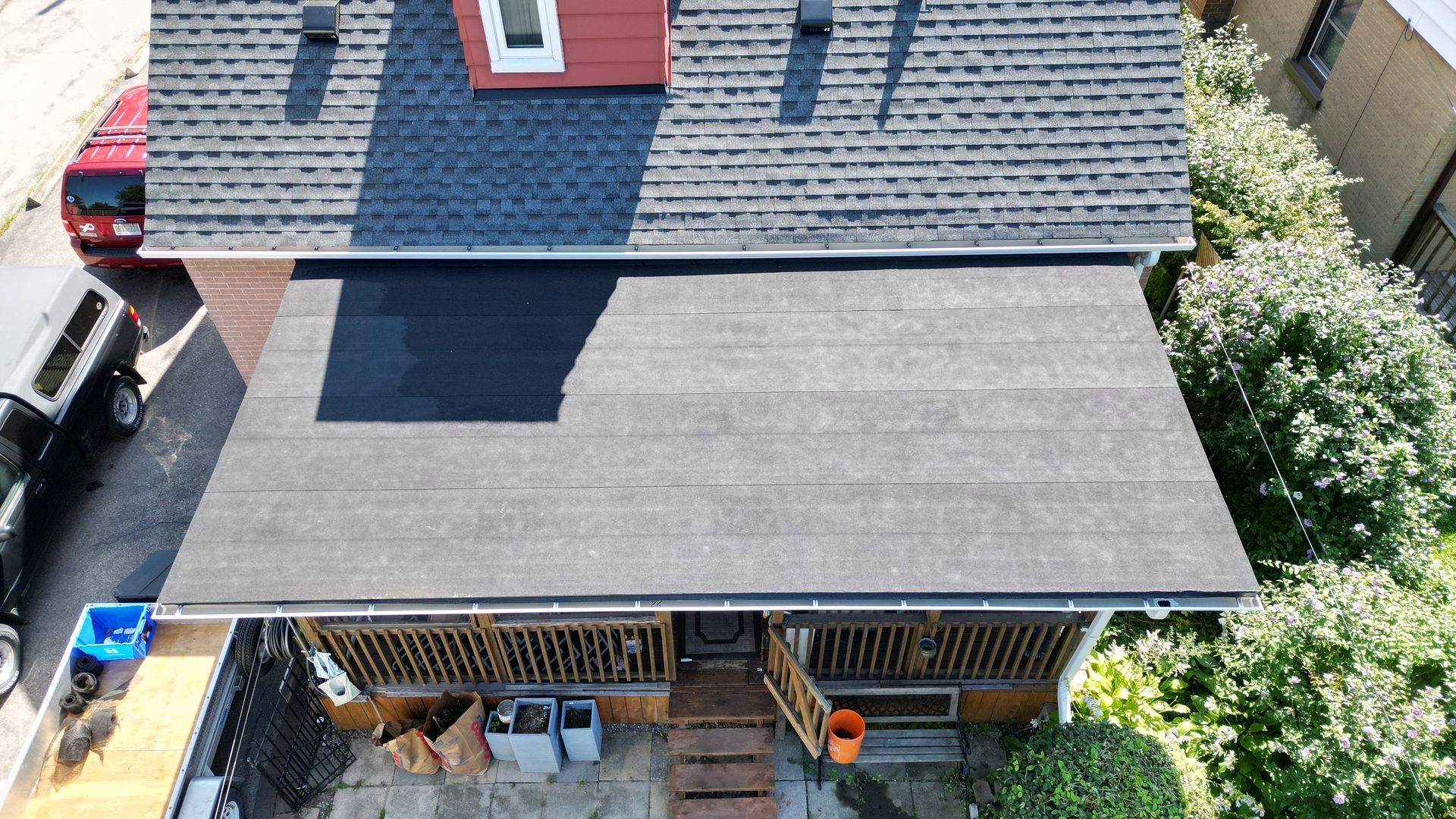 An aerial view of a house with a black roof