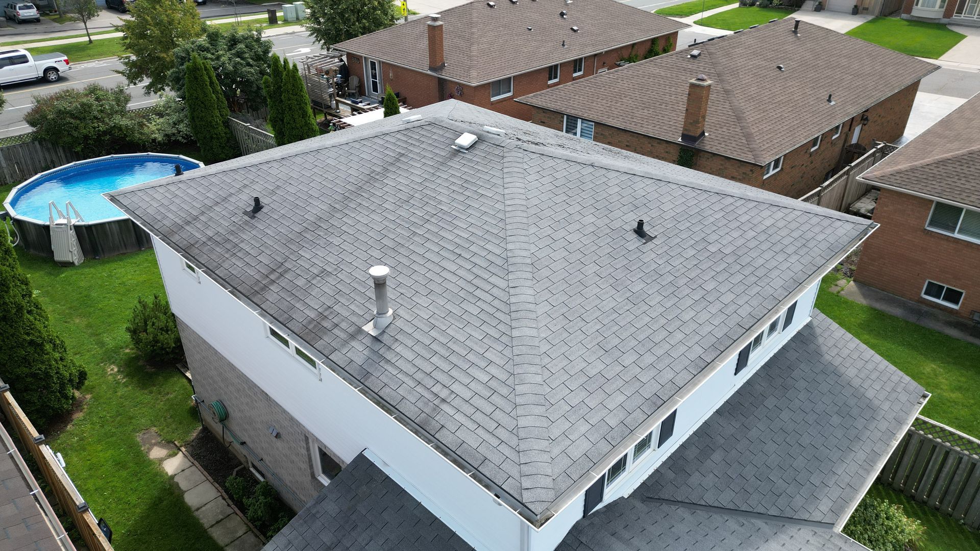 An aerial view of a house with a pool in the backyard