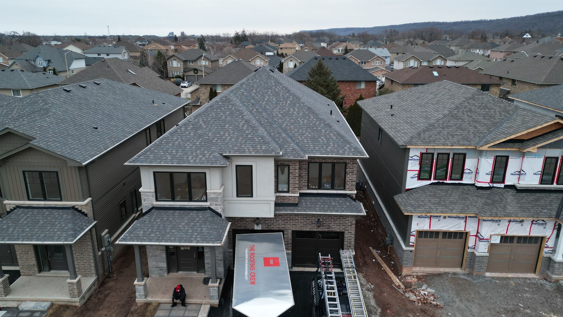 An aerial view of a residential area with houses under construction