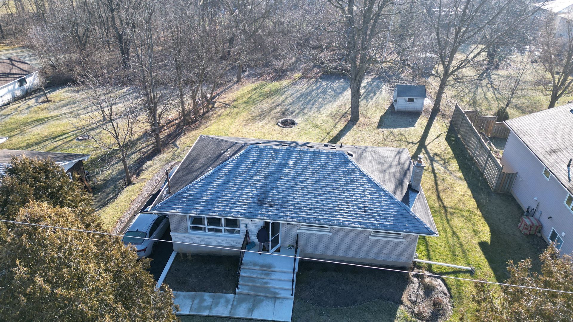 An aerial view of a house with a broken roof