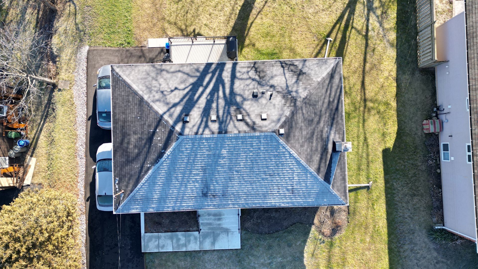 An aerial view of a house with a blue roof