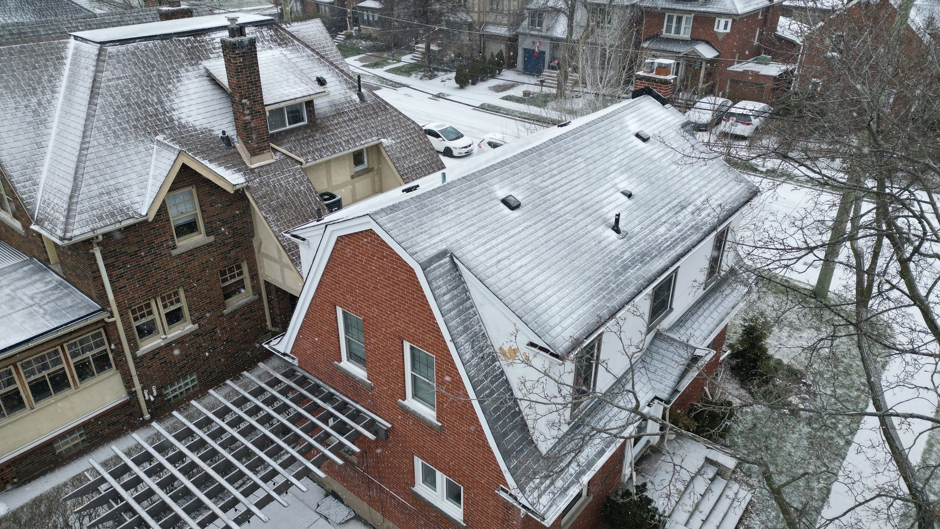 An aerial view of a row of houses covered in snow.