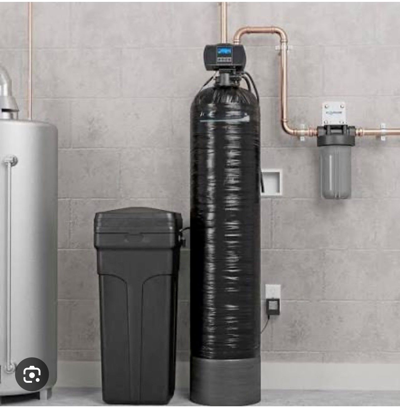 Person working on under-sink water filter system, wearing gloves, in a cabinet.