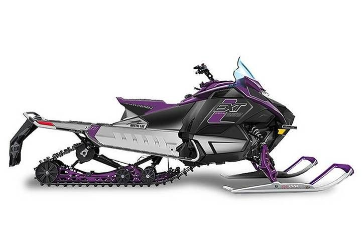 Purple and black snowmobile with a clear windshield, on a white background.