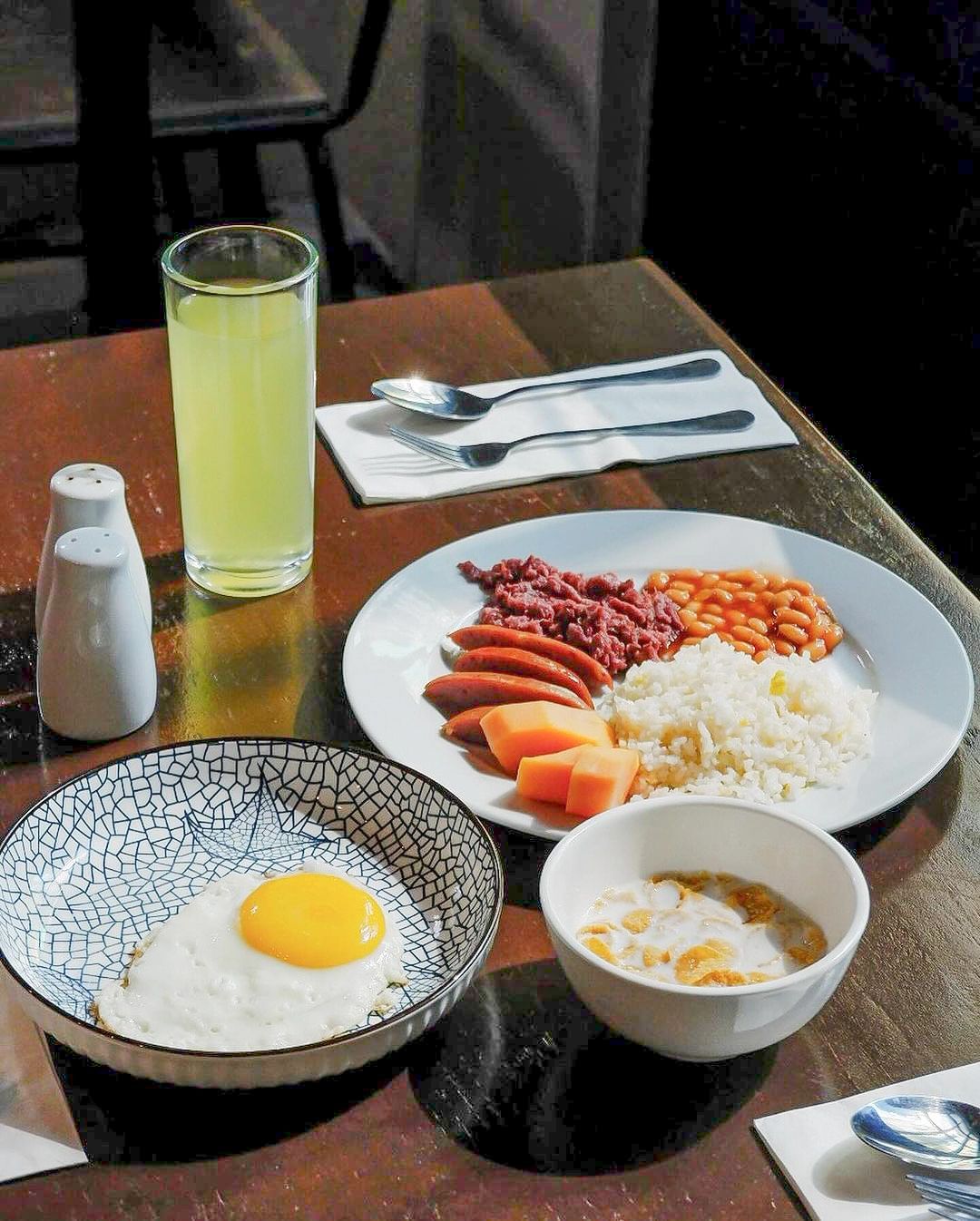 A table topped with plates of food and a glass of lemonade offered in Y2 Residence Hotel