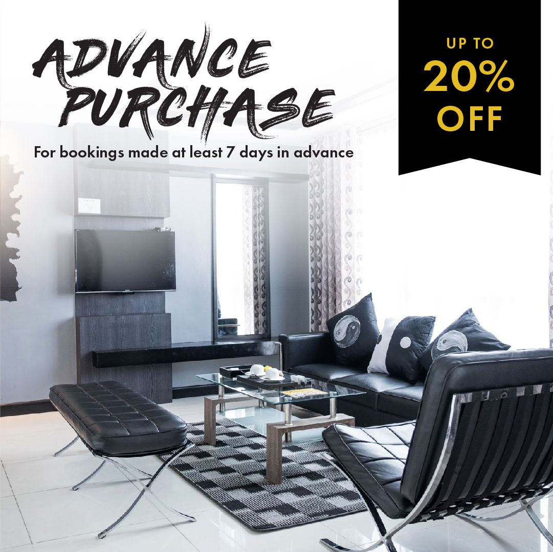 Hotel room with a black and white interior, promoting an advance purchase offer of up to 20% off.