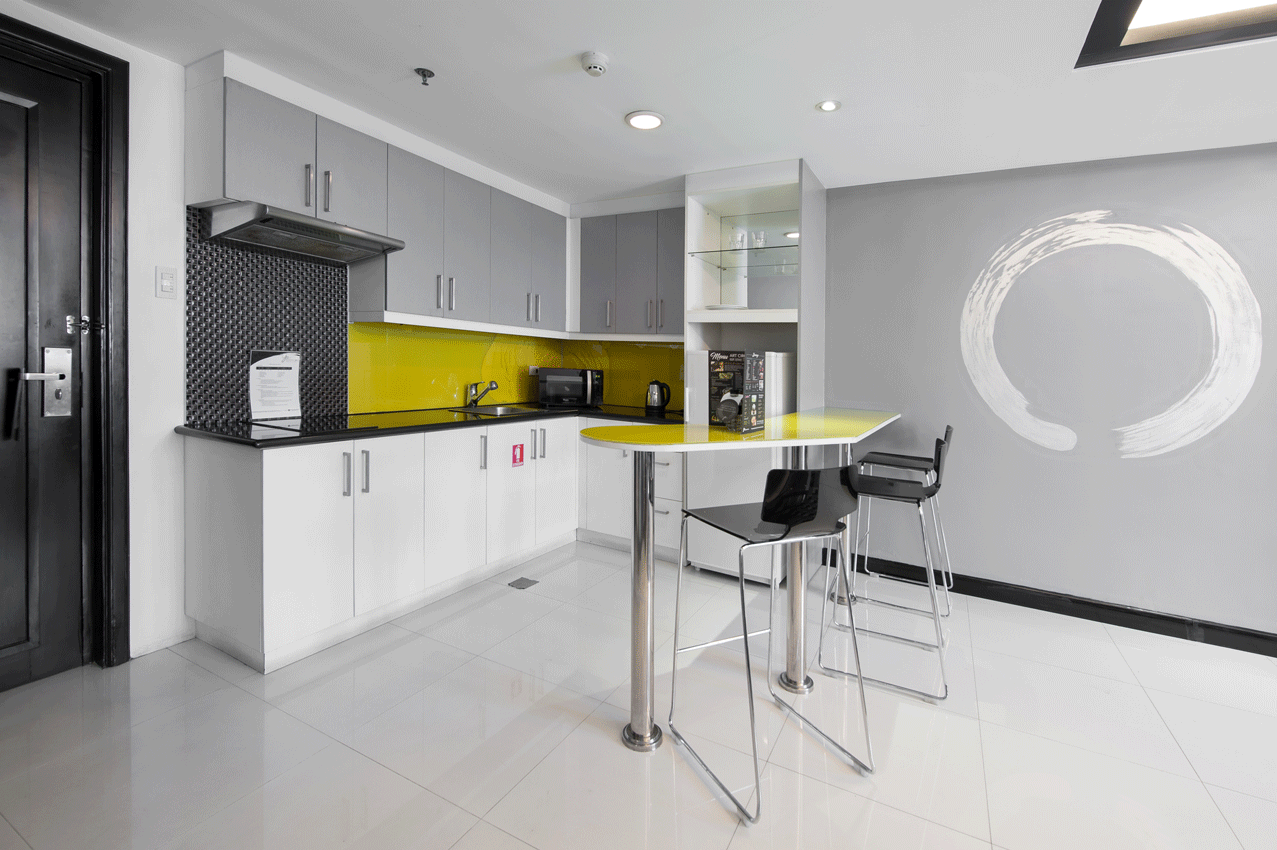 A kitchen with a table and chairs in One bedroom premier at Y2 Residence