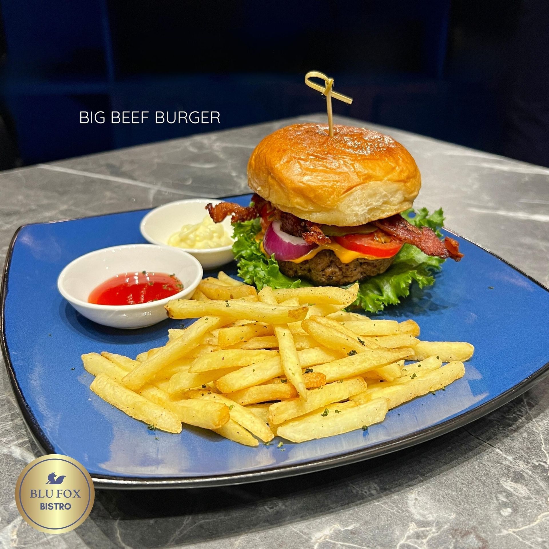 The 'Big Beef Burger' and fries, a delicious meal available at Y2 Residence Hotel Blu Fox Bistro, making for the best hotel staycation in Makati.