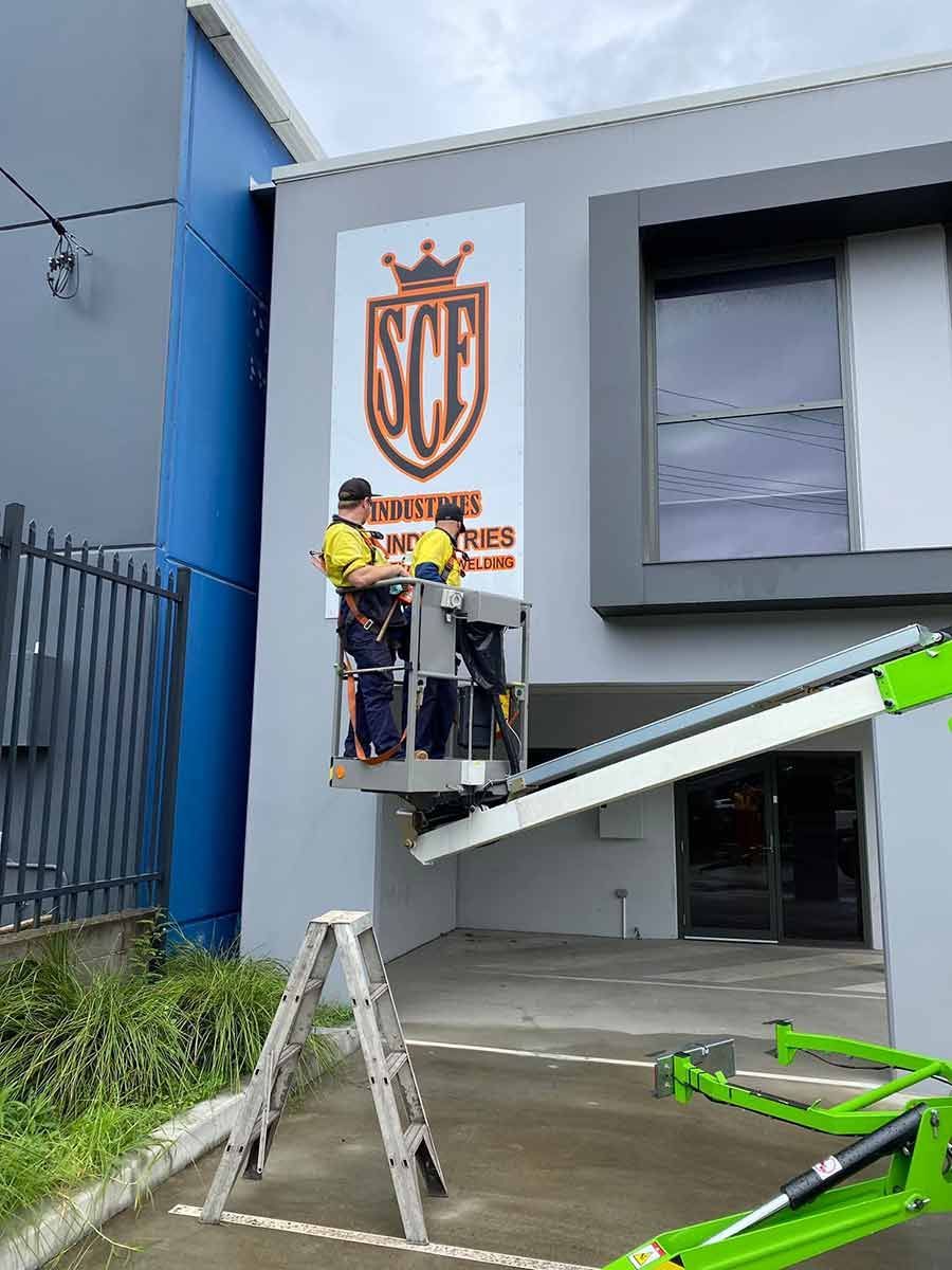 A Man is Standing on a Construction Lift in Front of a Building —  SCF Industries Pty Ltd in Albion Park Rail, NSW
