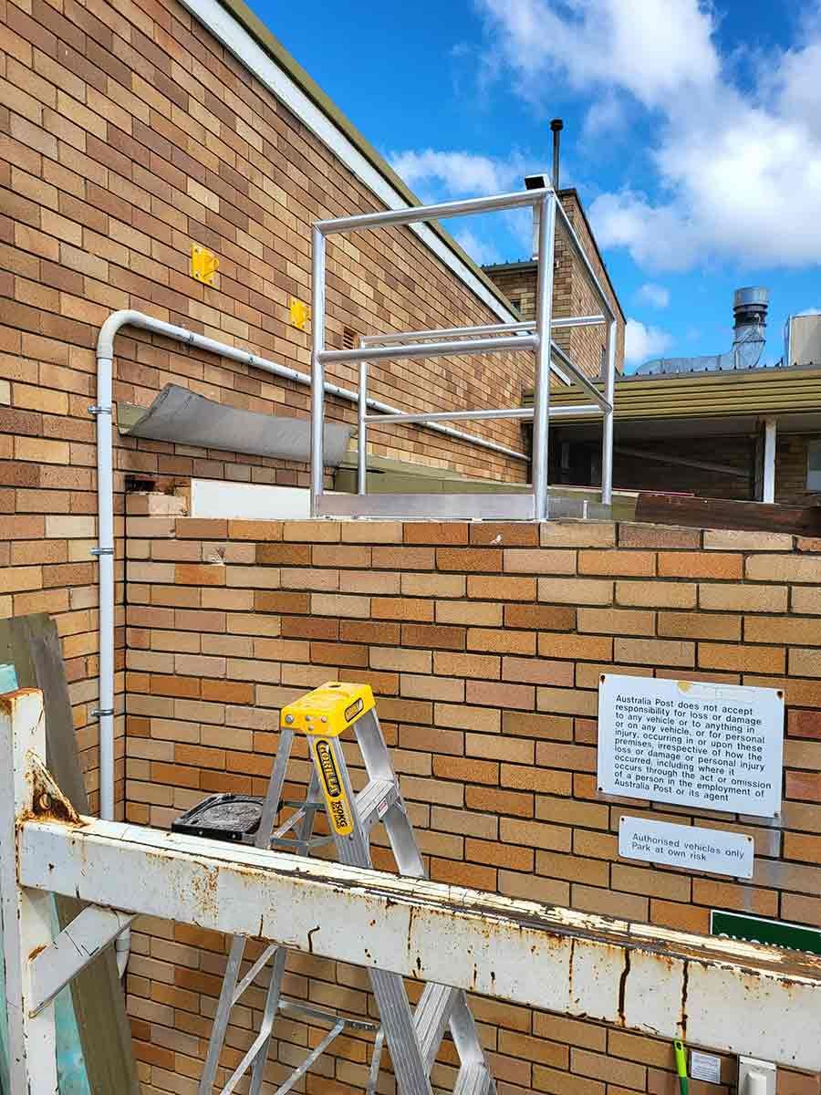 A Ladder is Leaning Against a Brick Wall With a Railing —  SCF Industries Pty Ltd in Albion Park Rail, NSW
