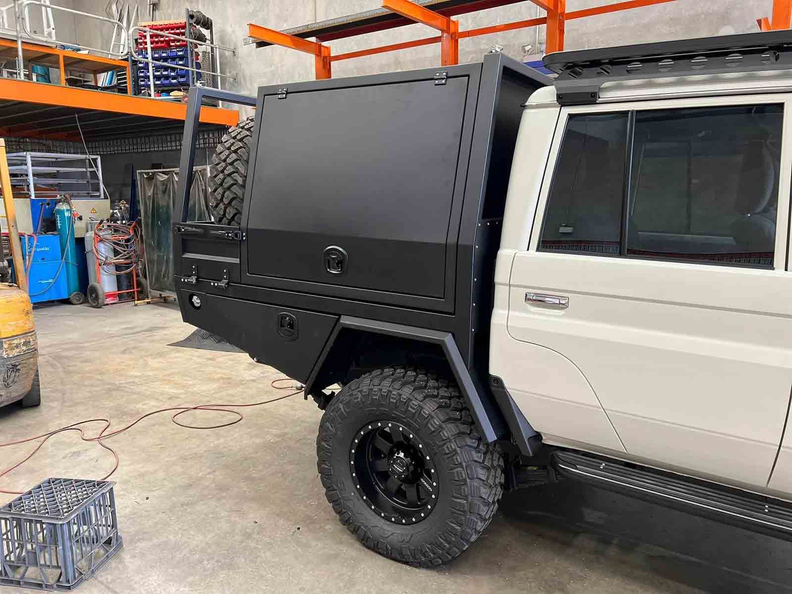 A White Truck With a Black Canopy is Parked in a Garage —  SCF Industries Pty Ltd in Albion Park Rail, NSW