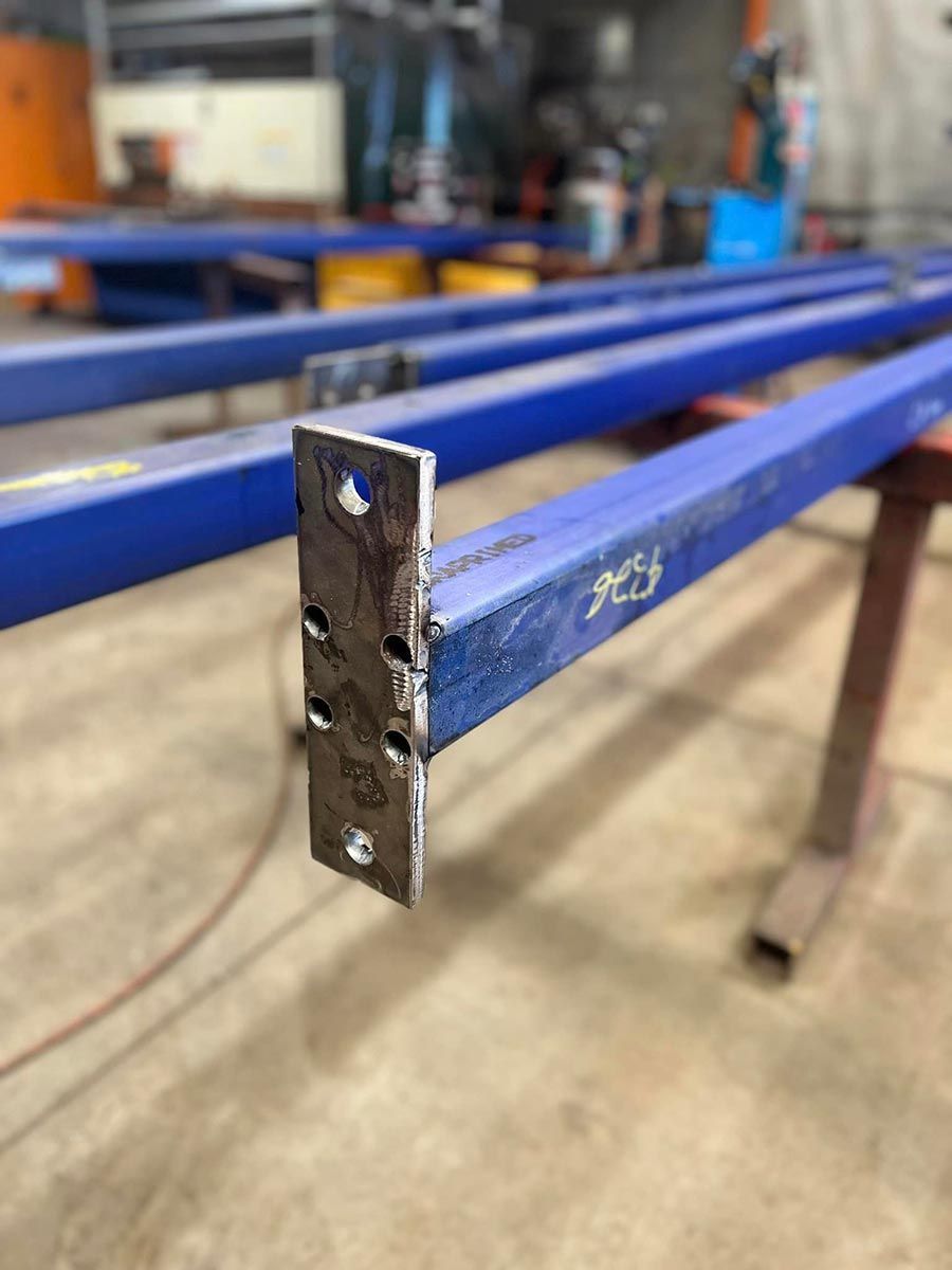 A Blue Metal Bar is Sitting on Top of a Wooden Table —  SCF Industries Pty Ltd in Albion Park Rail, NSW