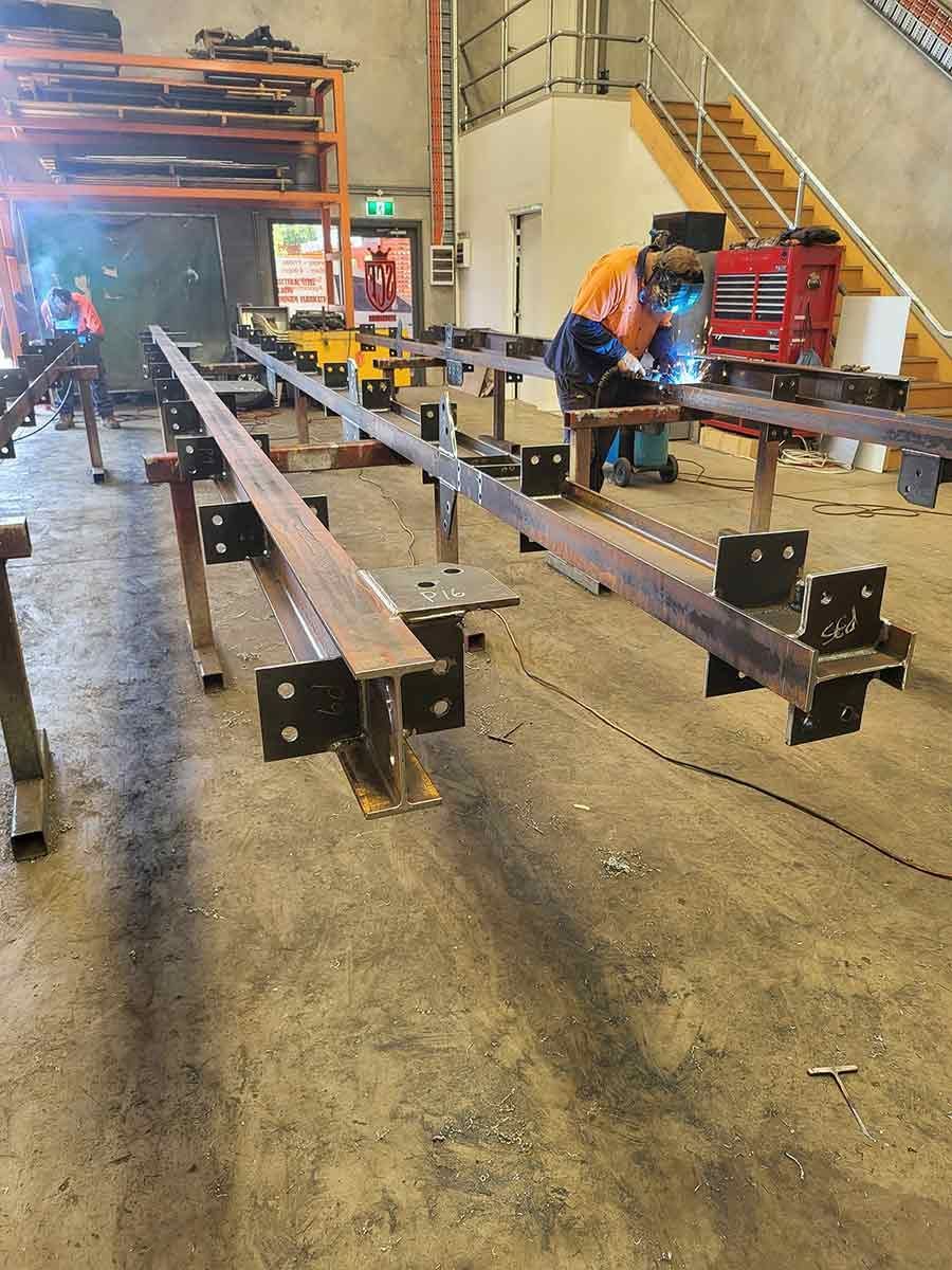 A Man is Welding a Metal Structure in a Factory —  SCF Industries Pty Ltd in Albion Park Rail, NSW