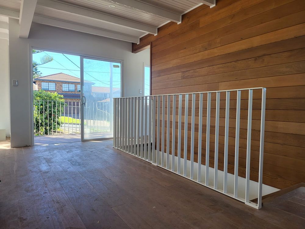 An Empty Room With a White Railing and Wooden Walls —  SCF Industries Pty Ltd in Albion Park, NSW