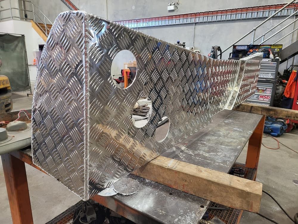 A Piece of Metal is Sitting on Top of a Wooden Table —  SCF Industries Pty Ltd in Albion Park, NSW