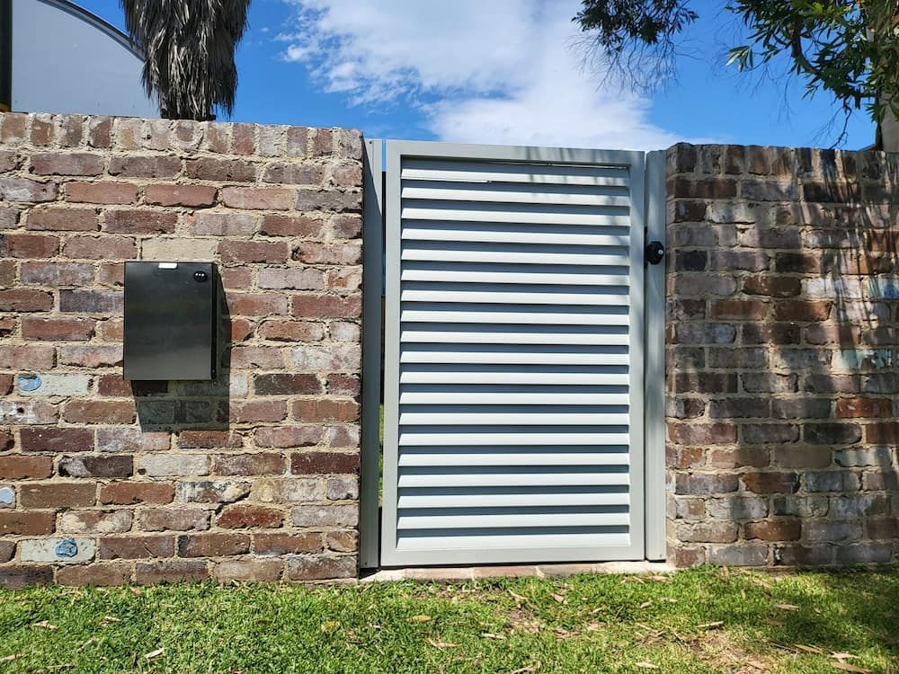 A Brick Wall With a Gate and a Mailbox in Front of It —  SCF Industries Pty Ltd in Shellharbour, NSW