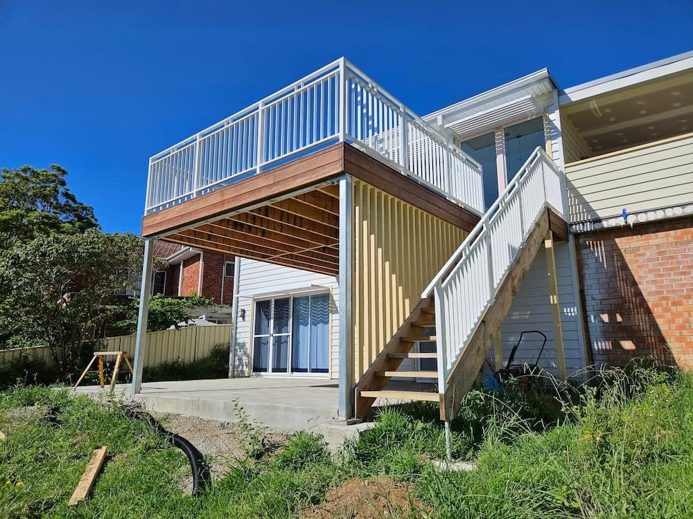A House With a Deck and Stairs on the Side of It —  SCF Industries Pty Ltd in Shellharbour, NSW