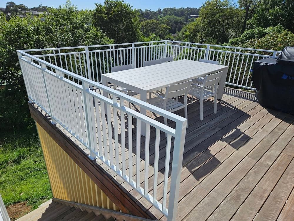 A Wooden Deck With a White Table and Chairs on It —  SCF Industries Pty Ltd in Shellharbour, NSW