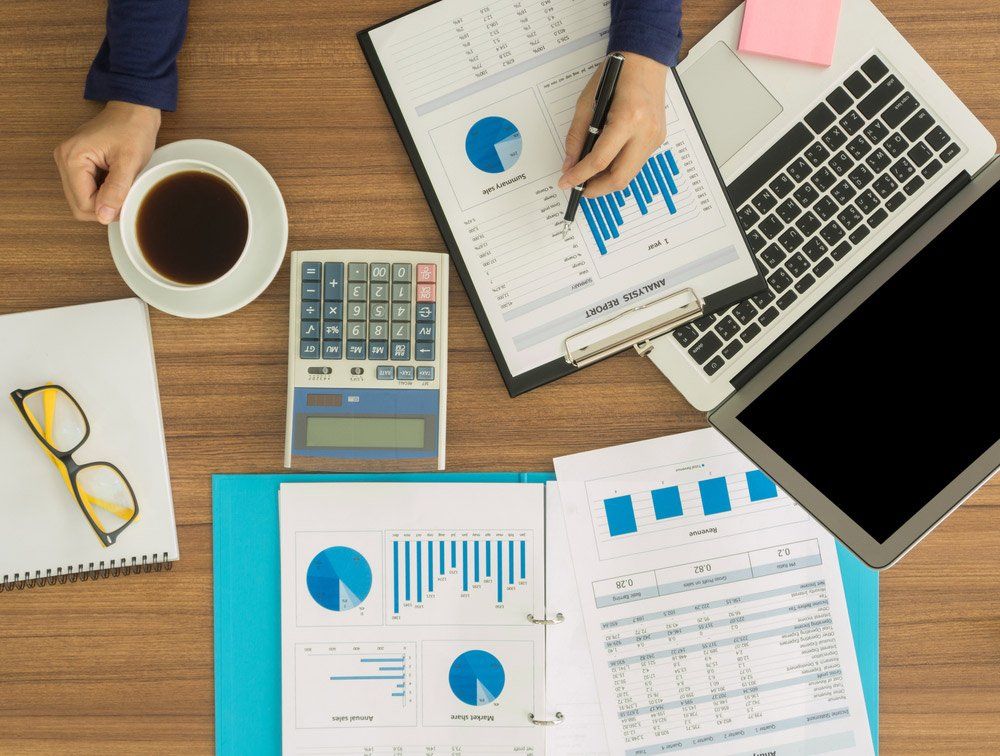 Financial Worker Analyzing Statistical Data On Desk — Integrity Bookkeeping Mobile Services in Gold Coast