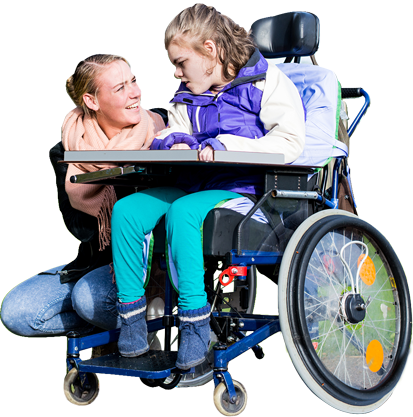 disabled child in a wheelchair with a care assistant