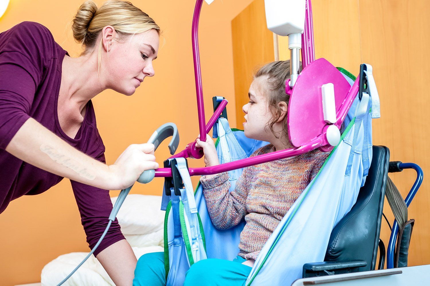 Care assistant assisting the disabled child