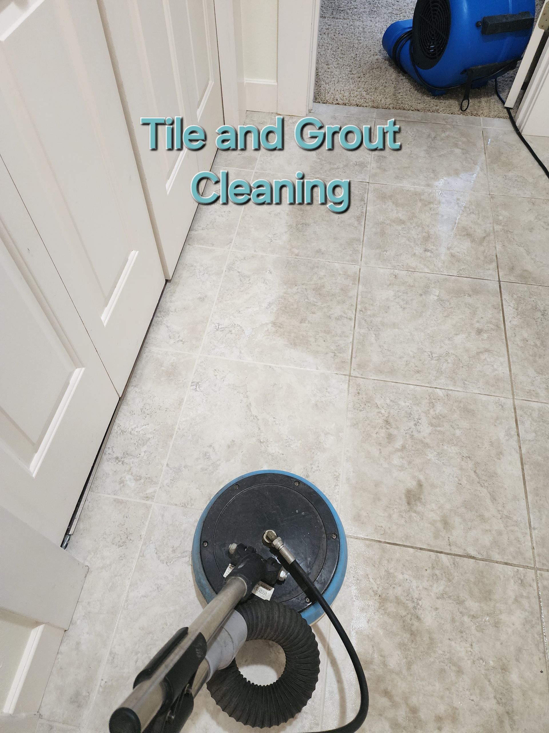 A tile and grout cleaning machine is sitting on a tiled floor.
