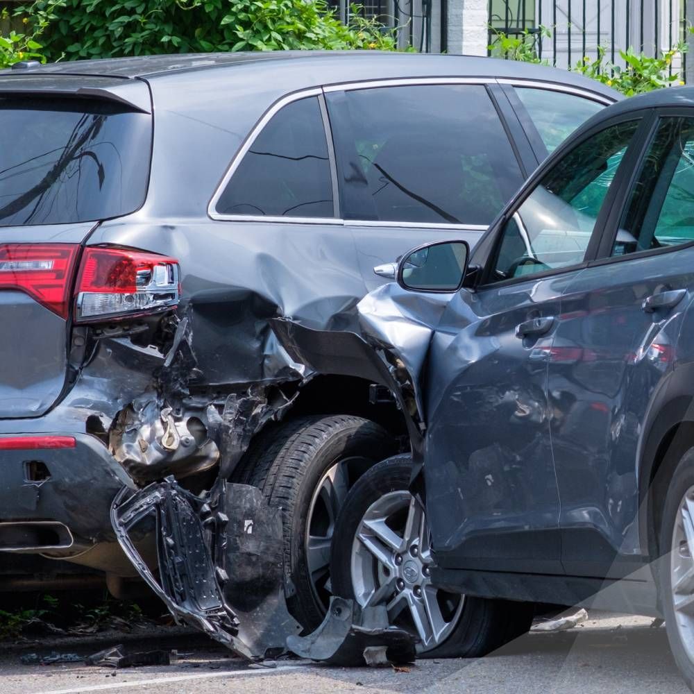 A gray suv has been damaged in a car accident.