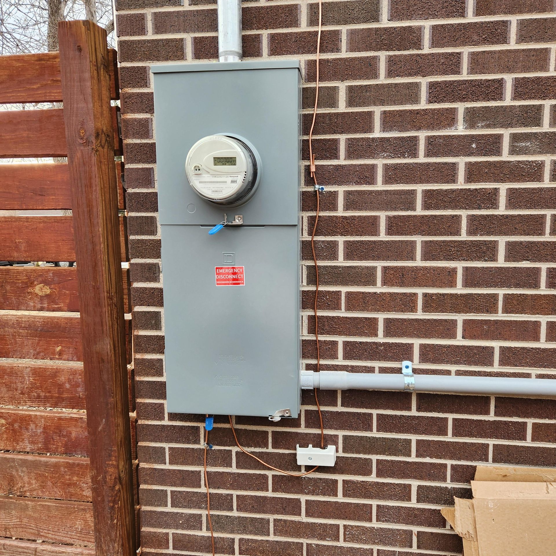 A brick wall with a meter attached to it.