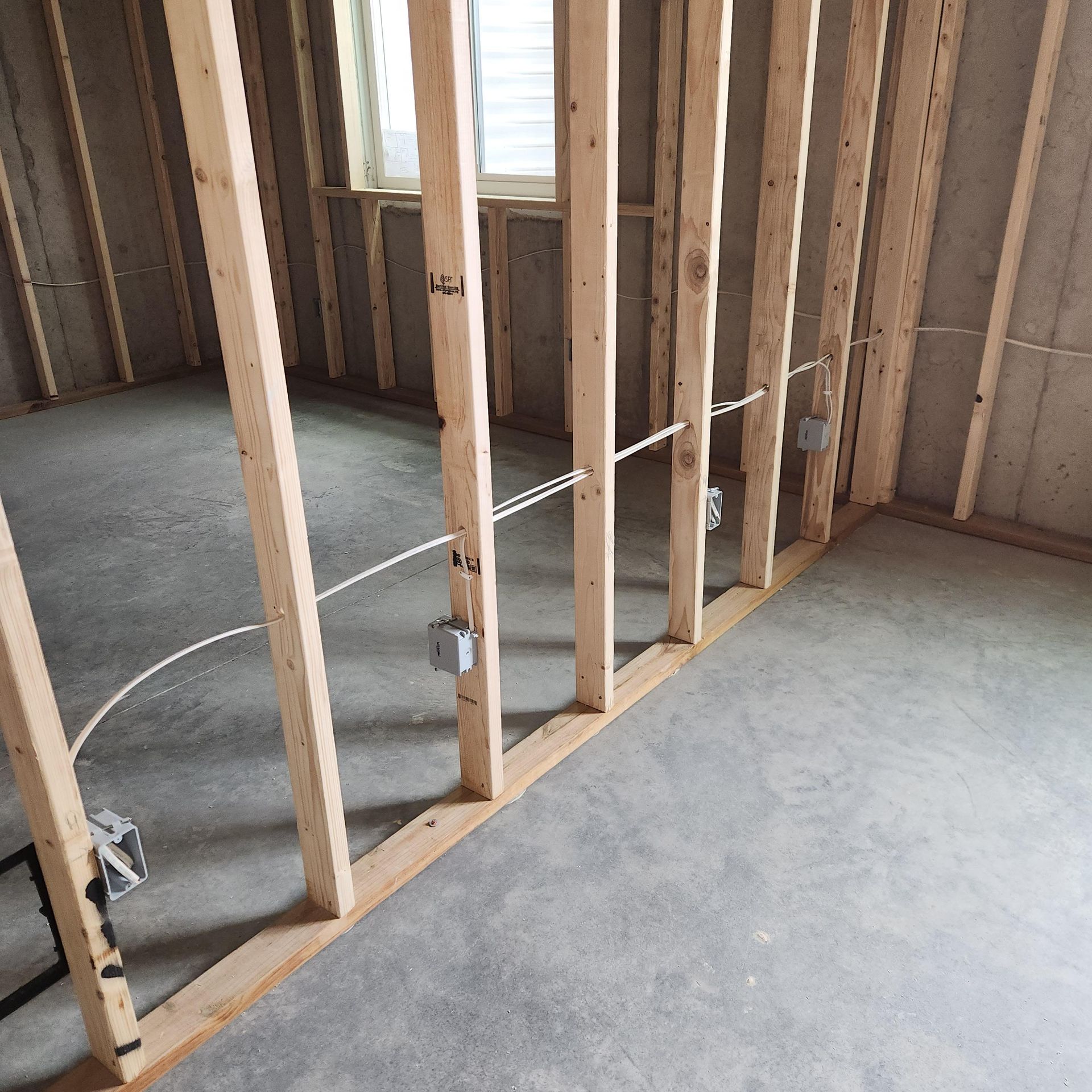A room that is being built with wooden beams and wires