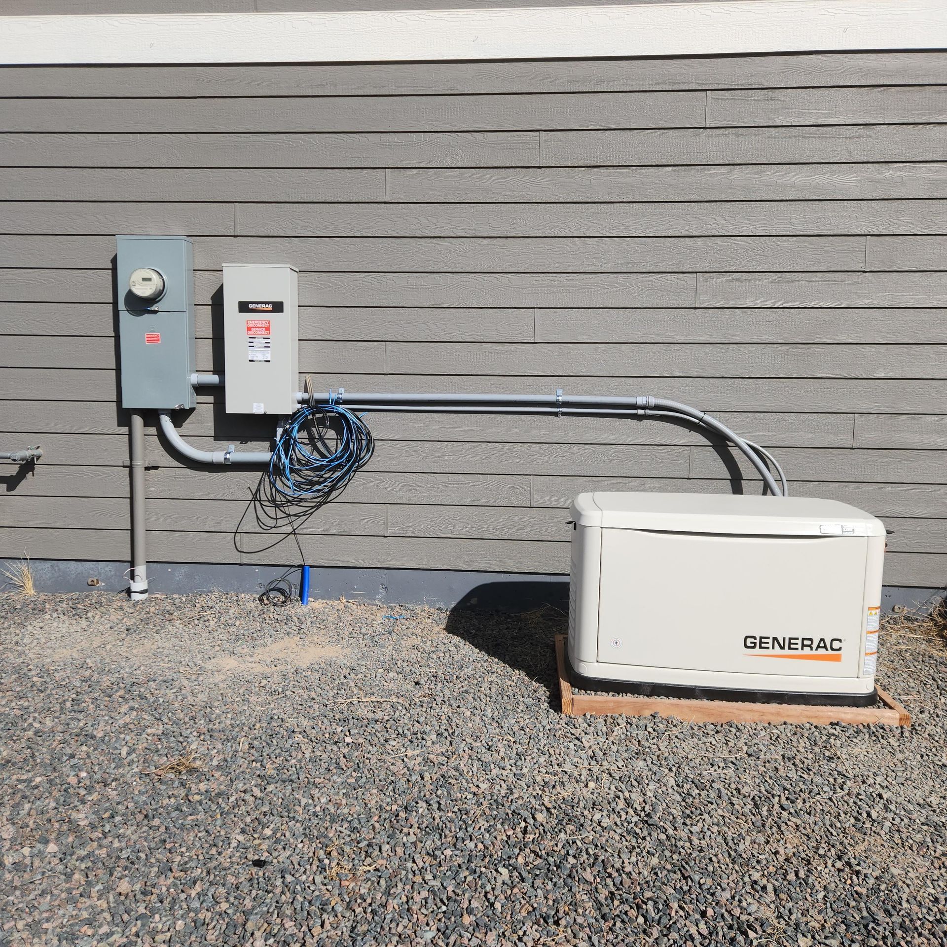 A genpac generator is attached to the side of a house