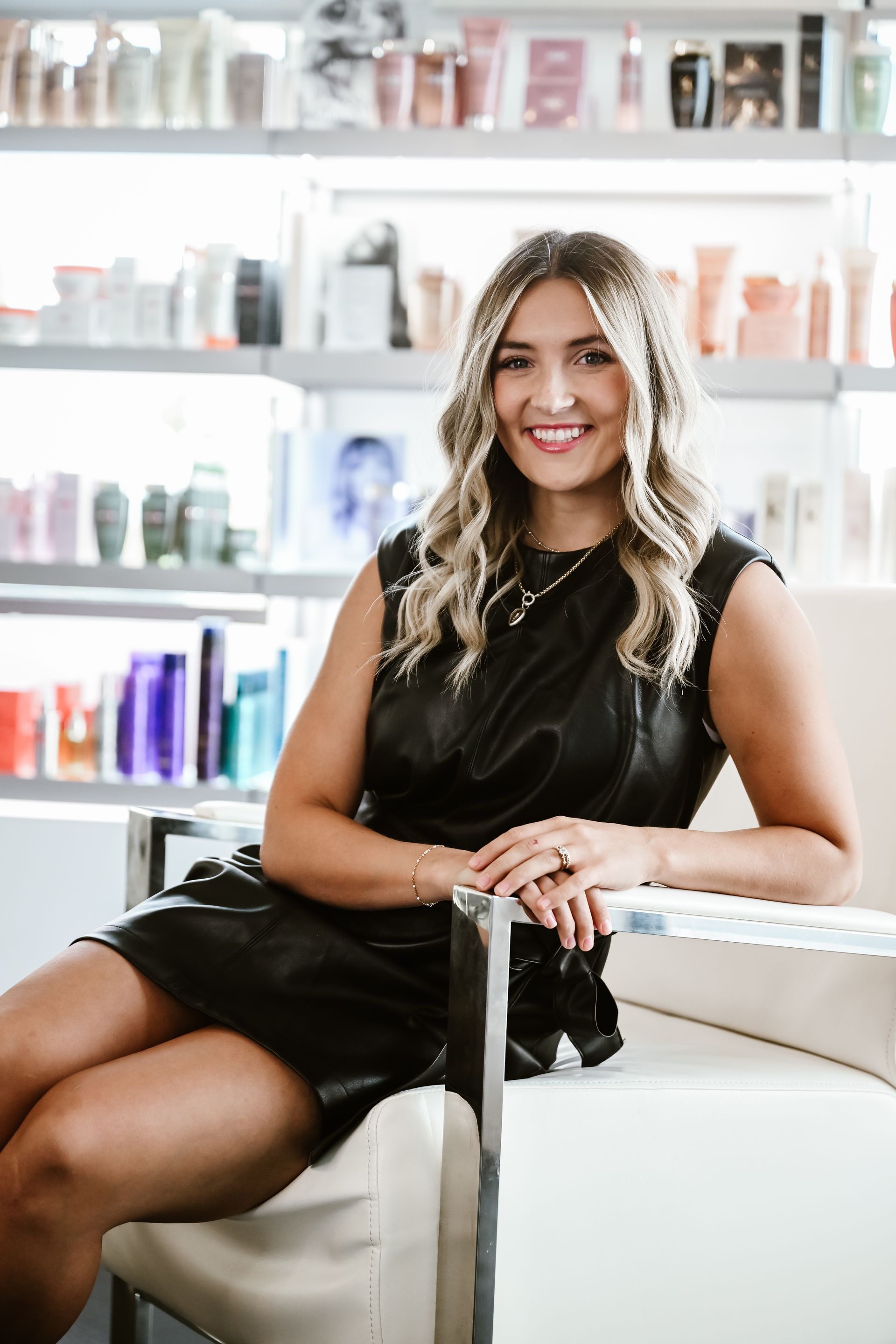 A woman is standing in a room with her arms crossed.