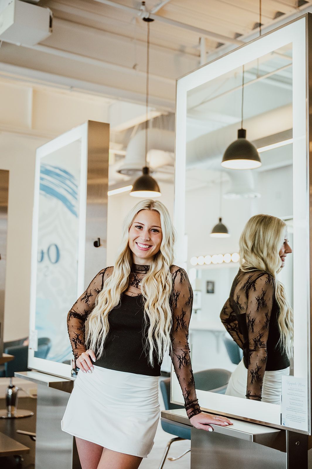 A woman is sitting in a chair in front of a window.