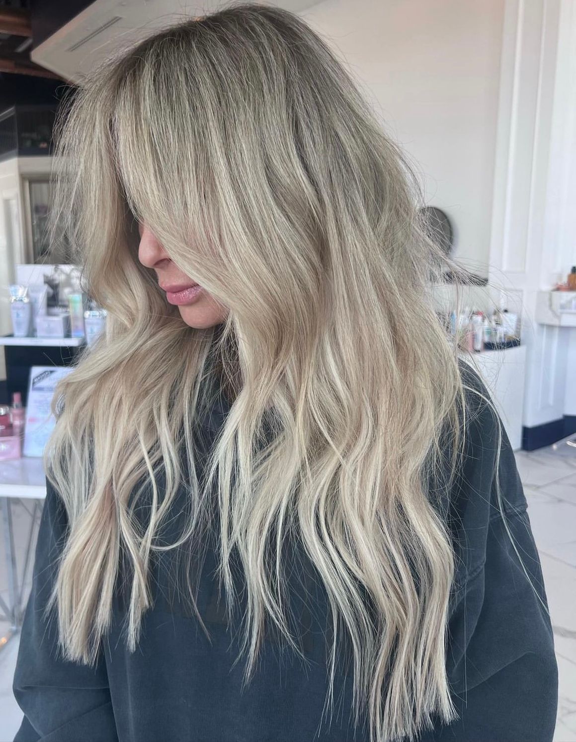 A blonde woman standing in a salon 