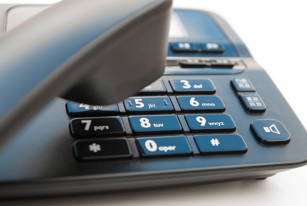 Close-Up of a Blue Landline Telephone With the Handset Lifted — Ryphen Electrical in Highton, VIC