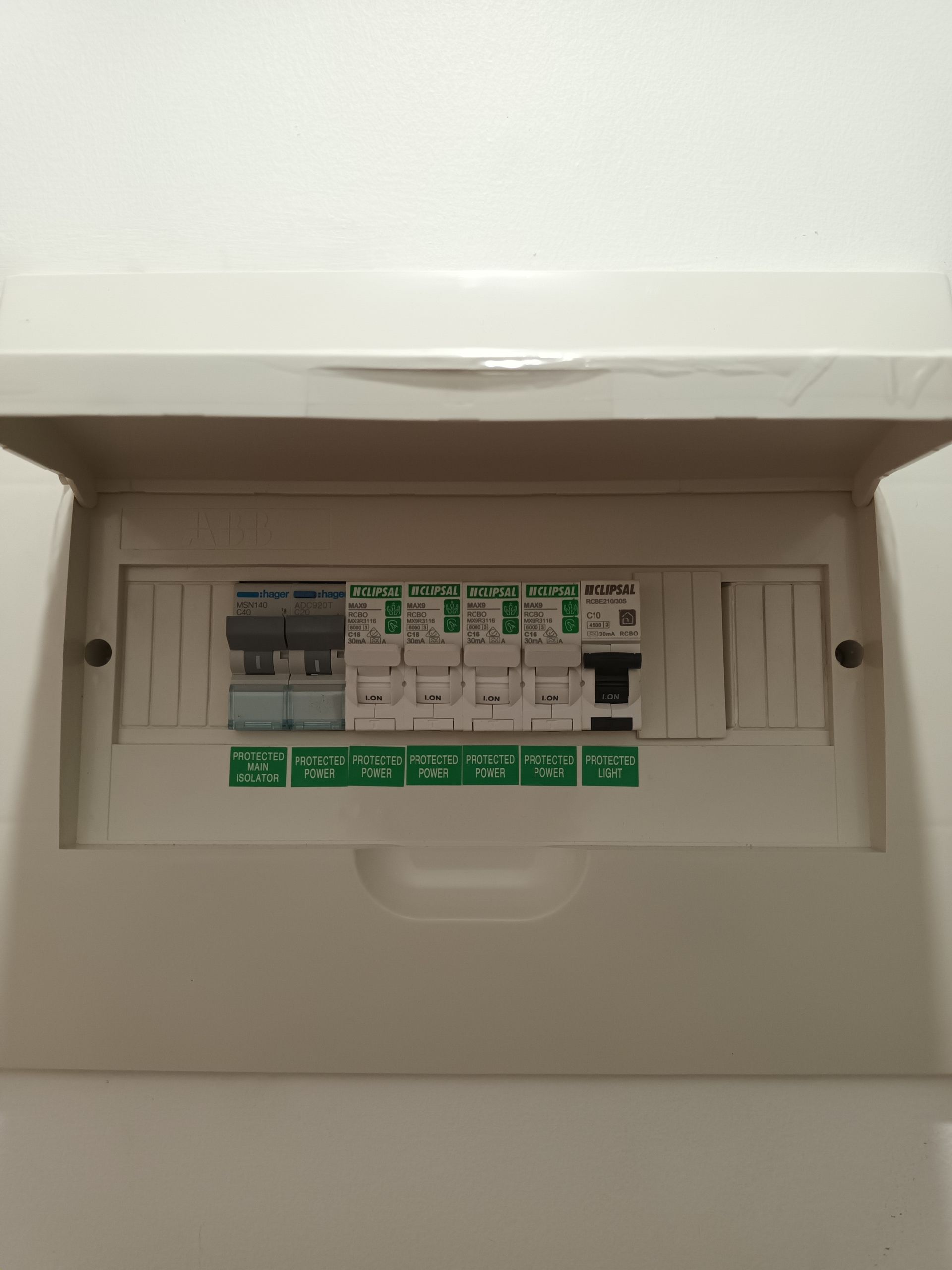 White electrical fuse box with several switches and labels. — Ryphen Electrical in Highton, VIC