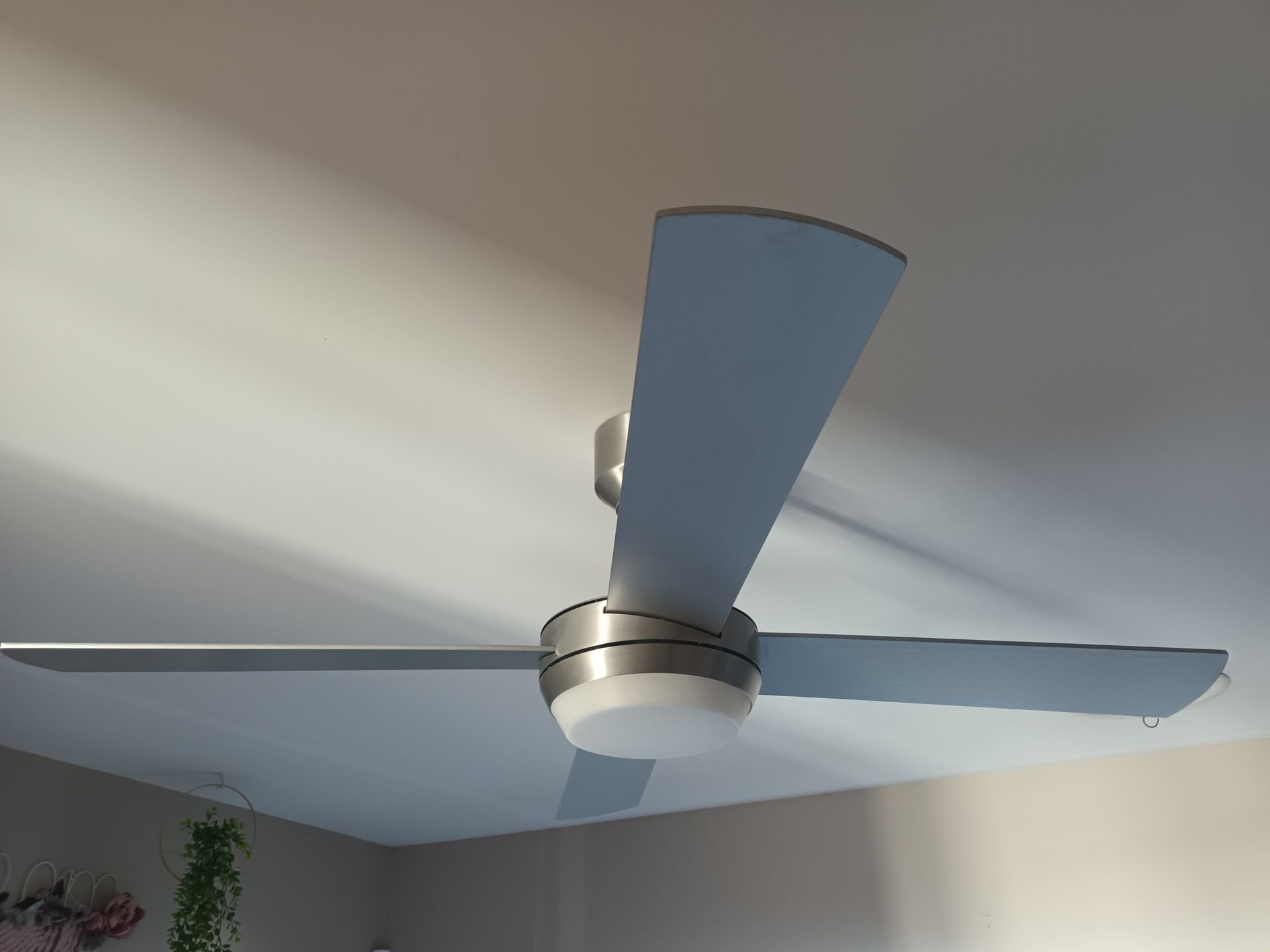 Ceiling fan with three gray blades, centered light, mounted on a white ceiling. — Ryphen Electrical in Highton, VIC